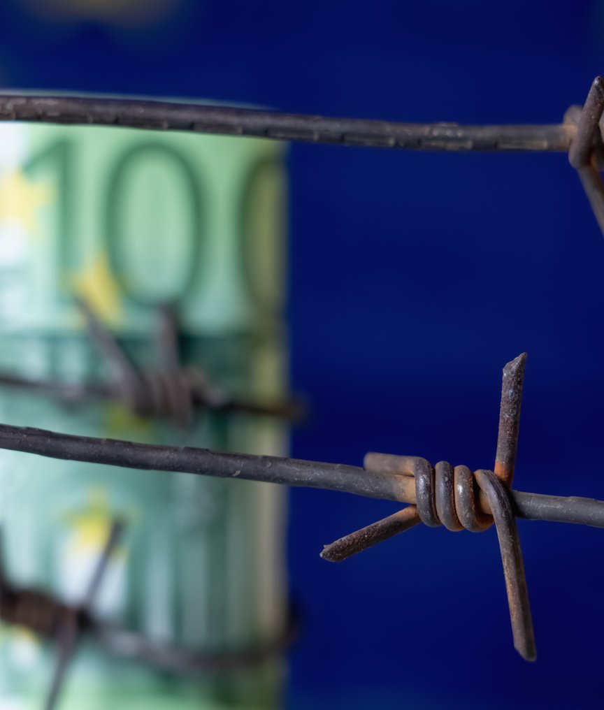 fence with euro bill and the european flag