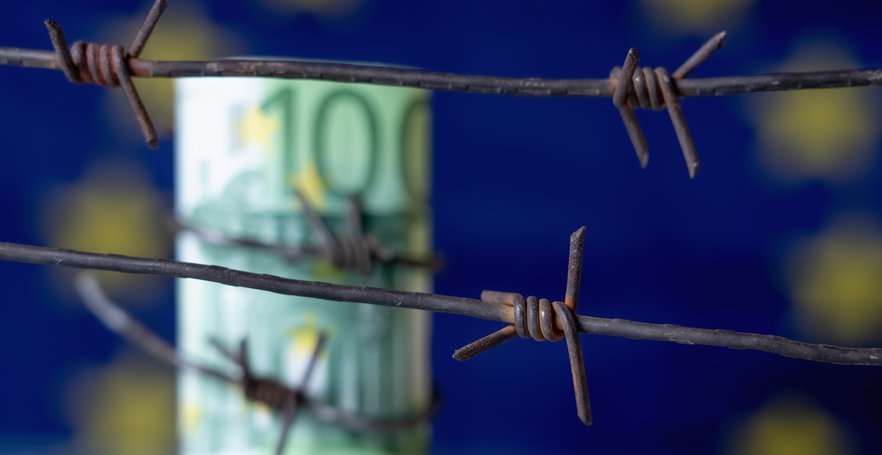 fence with euro bill and the european flag