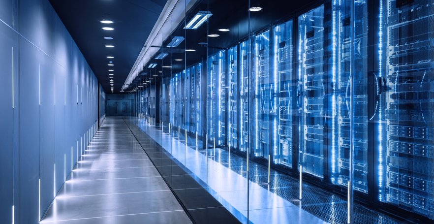 High-tech data center featuring multiple server racks illuminated by blue LED lighting in a clean, r