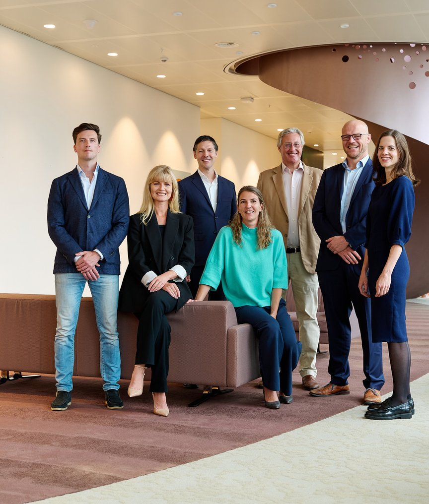 The NautaDutilh Defence team pictured in a modern office environment.