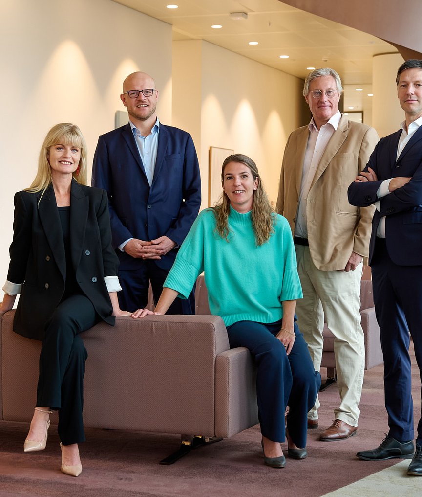 The NautaDutilh Defence team pictured in a modern office environment.